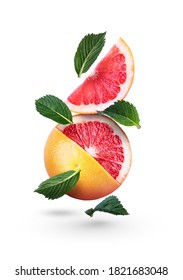 Grapefruits with green mint leaves on a white background. Falling citrus. Grapefruit