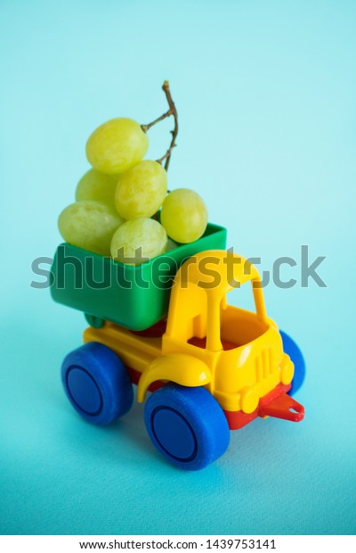 grapes natural vitamins are\
in the back of a truck in a children\'s toy car food delivery truck\
logistics