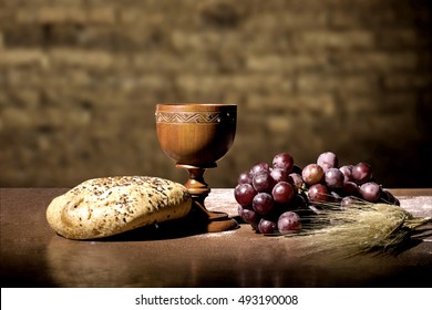 grapes, wheat, bread and wine in a wood table - Shutterstock ID 493190008