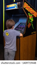 GRAPEVINE, TEXAS - May 5, 2019: A Young Boy Enjoys Frogger In The 80s Arcade At The Annual Main Street Days Festival.