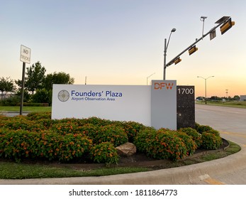 Grapevine, TX / USA - September 6, 2020: A sunset view of DFW Founders' Plaza sign with flower bushes in Grapevine, Texas