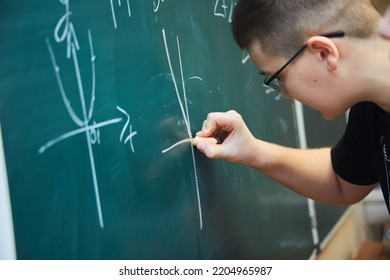 A graph of functions from mathematics is written by a student on a green school board. The concept of education and training.