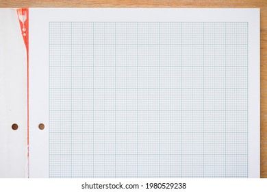 Graph paper notebook. Real paper on a wooden desk, ideal for a school or math background, concept or template