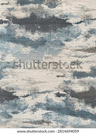 Graphic background of random washed clouds and brush strokes pattern in blue, grey, and white color. Grunge and dirt pattern. For illustration, painting, fabric, wallpaper. Seamless background texture.