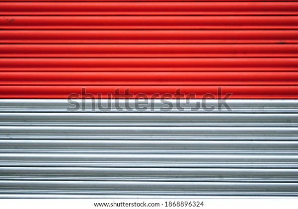 Graphic Close Up of Metal Roller Shutter Painted Red and\
Silver 