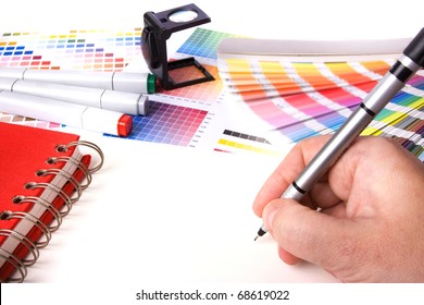 Graphic Design And Coloured Swatches And Pens On A Desk