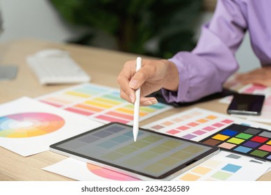 Graphic Design Process. Creative designer using tablet for color selection and design work.
