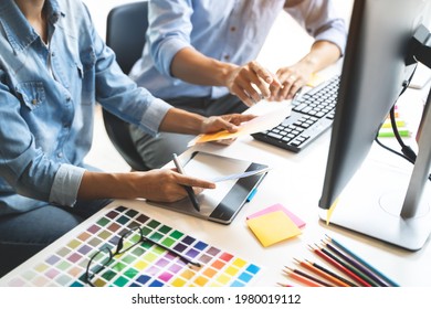 Graphic design using graphics tablet drawing creative logo design brand designer sketch with Color swatch samples - Shutterstock ID 1980019112