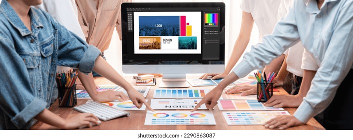 Graphic designer brainstorming logo and graphic art at busy artistic workshop, laptop display workspace. Experimenting color palette and pattern for creative design. Panorama shot. Scrutinize - Powered by Shutterstock