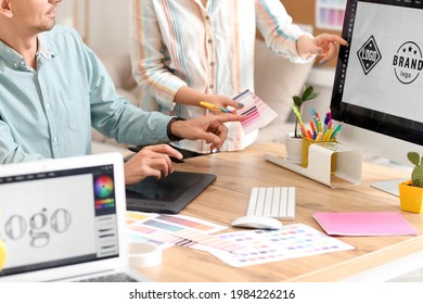 Graphic designer with colleague working in office - Shutterstock ID 1984226216