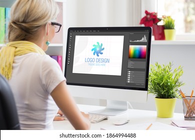 Graphic designer creating company's logo on desktop computer - Shutterstock ID 1864994488