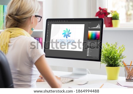 Graphic designer creating company's logo on desktop computer