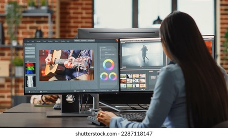 Graphic designer creating professional movie content with filmmaking software in agency office, creative digital film. Cinematographer editing video footage with lighting and focus, videography.