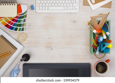 Graphic Designer Desk Essentials Top View With Wooden Texture Background.