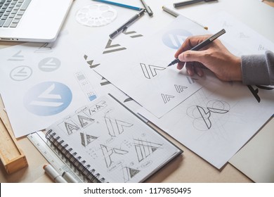 Graphic designer drawing sketch design creative Ideas draft Logo product trademark label brand artwork. Graphic designer studio Concept. - Shutterstock ID 1179850495