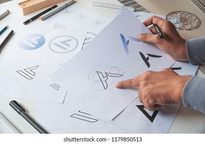 Graphic designer drawing sketch design creative Ideas draft Logo product trademark label brand artwork. Graphic designer studio Concept. - Shutterstock ID 1179850513