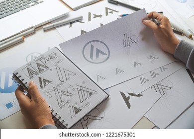 Graphic designer drawing sketch design creative Ideas draft Logo product trademark label brand artwork. Graphic designer studio Concept. - Shutterstock ID 1221675301
