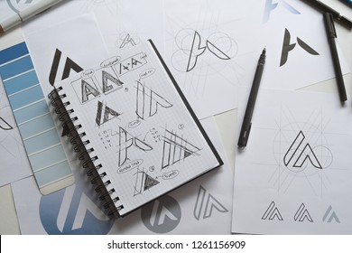 Graphic designer drawing sketch design creative Ideas draft Logo product trademark label brand artwork. Graphic designer studio Concept. - Shutterstock ID 1261156909