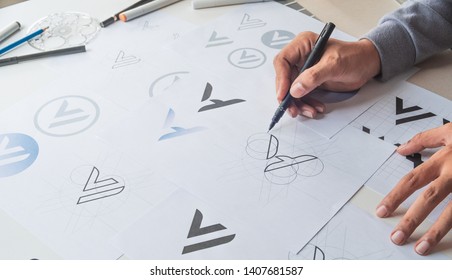 Graphic designer drawing sketch design creative Ideas draft Logo product trademark label brand artwork. Graphic designer studio Concept. - Shutterstock ID 1407681587