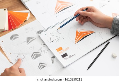 Graphic designer drawing sketches logo design. The concept of a new brand. Professional creative occupation with idea. - Shutterstock ID 1613250211
