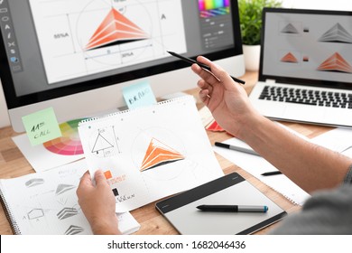 Graphic designer drawing sketches logo design. The concept of a new brand. Professional creative occupation with idea. - Shutterstock ID 1682046436