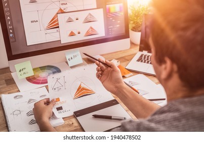 Graphic designer drawing sketches logo design. The concept of a new brand. Professional creative occupation with idea. - Shutterstock ID 1940478502