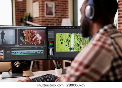 Graphic designer editing footage on software, working to edit video montage with color grading and audio effects. Sound and film production content, making creative movie on computer. - Shutterstock ID 2188350765