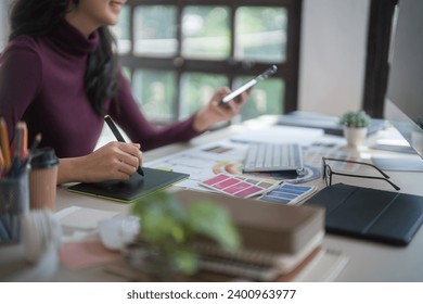 Graphic designer freelance women thinking creative ideas and using digital tablet to sketching logo brand while working to designing about graphic design with technology equipment in home studio. - Powered by Shutterstock