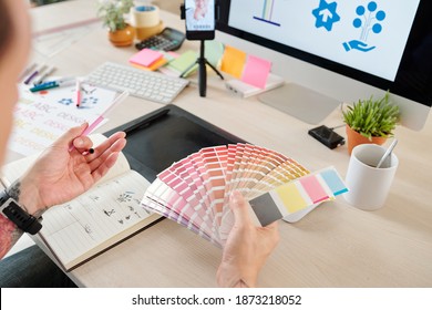Graphic designer having online meeting with clinet when choosing best shadow of pink color for company logo