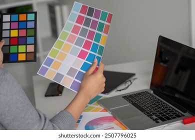 Graphic designer reviewing color palette for creative project - Powered by Shutterstock