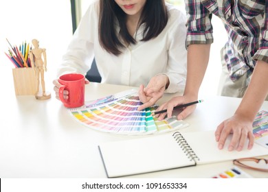 Graphic designer using color swatch to do his work at modern office. Architect using work tools and sample colour catalog. - Shutterstock ID 1091653334