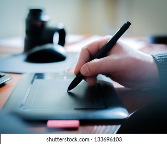 Graphic designer using digital tablet and computer in the office