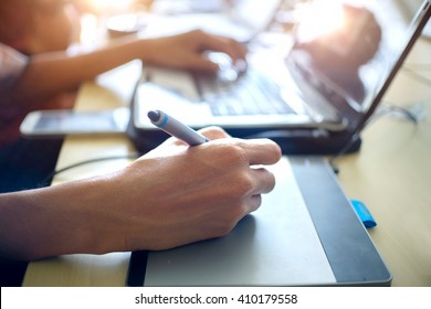 Graphic designer using digital tablet and computer. - Powered by Shutterstock