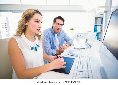 Graphic designer using a graphics tablet in her office - Powered by Shutterstock - Get 15% off with code: PIKWIZARD15
