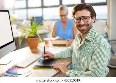 Graphic designer using graphic tablet in office