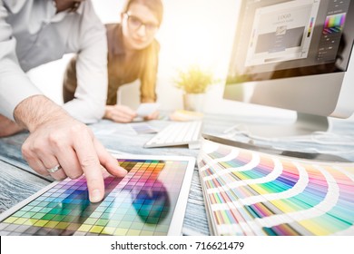 Graphic designer at work. Color swatch samples. - Powered by Shutterstock