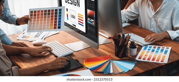 Graphic designer work on computer laptop and with graphic drawing pen while brainstorming unique design with professional graphic team in modern digital studio workplace. Panorama shot. Scrutinize - Powered by Shutterstock