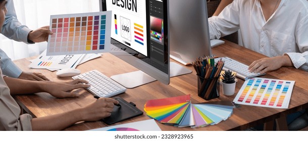 Graphic designer work on computer laptop and with graphic drawing pen while brainstorming unique design with professional graphic team in modern digital studio workplace. Panorama shot. Scrutinize - Powered by Shutterstock