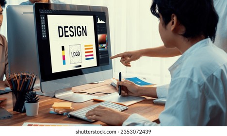 Graphic designer work on computer laptop and with graphic drawing pen while brainstorming unique design with professional graphic team in modern digital studio workplace. Panorama shot. Scrutinize - Powered by Shutterstock