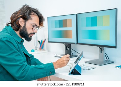 Graphic designer working with computer digital tablet stylus pen smartphone and color swatch - creative man at modern office. Architect using work tools and sample color catalog. High quality photo - Shutterstock ID 2231380911