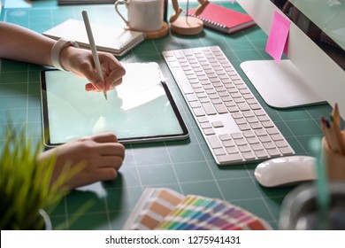 Graphic Designer Working With Digital Drawing Tablet At Her Office