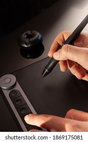 Graphic Designer Working With Graphics Tablet. Dark Background