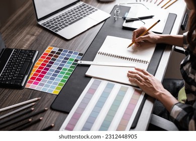 Graphic designer working with sketching logo design at office