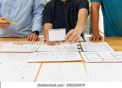 Graphic designers work together with UX UI designer planning application template layout framework for mobile phone computer mobile - Shutterstock ID 1901526979