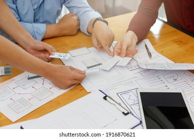 Graphic designers work together with UX UI designer planning application template layout framework for mobile phone computer mobile - Shutterstock ID 1916870621