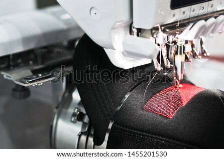 Graphic embroidery machine on the hat