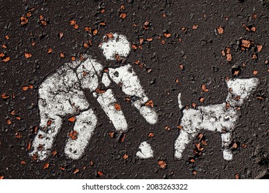 Graphic Sign On A Asphalt To Pick Up Your Dog Poo. White Color On Dark. Human And Dog Abstract Figure. Call And Reminder To Dog Owners Keep Environment Clean And Tidy. Visual Aid