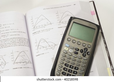 A Graphing Or Scientific Calculator Resting On A Calculus Math Book