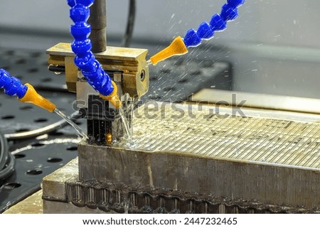The graphite electrode working on EDM machine with liquid coolant method. The mold and die manufacturing process by graphite electrode.