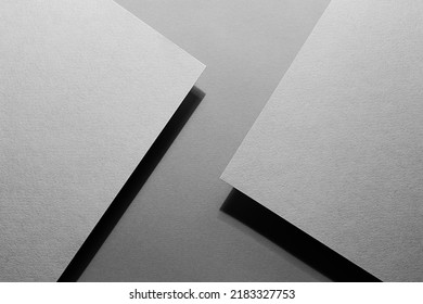 Graphite grey abstract textured geometric background with fly inclined rectangle paper sheets with corners and black shadows lines in  in luxury business style for design, top view, copy space.